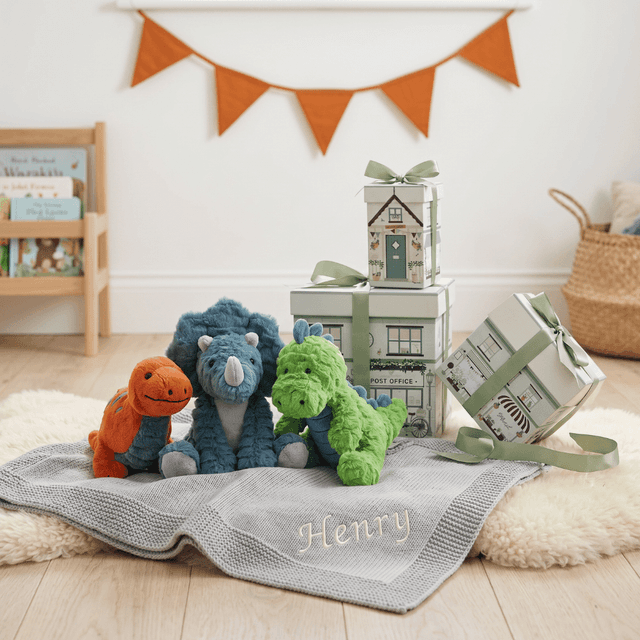 image of Steiff dinosaur with knitted blanket